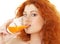 Lovely redhead drinking orange