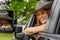 A Lovely Redhead Model Sits In Her Truck While Wearing A Cowboy Hat On Her Farm