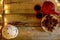 Lovely rustic wooden table with red teapot and cups, chocolate star cookies and white tealight lantern. With copy space.