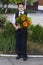 The lovely school student costs with a bouquet of flowers