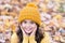 Lovely season. Autumn skin care routine. Kid wear warm knitted hat. Warm woolen accessory. Girl long hair happy face