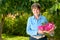 Lovely Senior in Her Garden with Pink Rose Bouquet