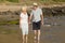 Lovely senior mature couple on their 60s or 70s retired walking happy and relaxed on beach sea shore in romantic aging together