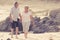 Lovely senior mature couple on their 60s or 70s retired walking happy and relaxed on beach sea shore in romantic aging together