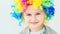 Lovely smiling girl in rainbow wig