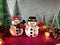 Lovely Snowman pink gliter background near ornament lighting bulb at silent night, holy night, Merry Christmas and hap