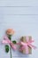 Lovely soft orange pink color rose tied by pink ribbon and brown gift box on white wood table background, sweet valentine present