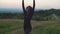 Lovely sporty fitness african woman practicing yoga warrior pose in mountains at dawn