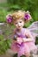 Lovely statuette, fairy doll in the fern foliage look beautiful eyes at you