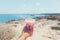 Lovely strawberry Milkshake in the hand on the beach at Cyprus, Ayia Napa, Blue lagoon. Soft colours, Summer time