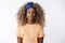 Lovely and stylish, hipster african-american curly blond woman in trendy outfit, headband, orange t-shirt, close eyes