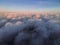 Lovely sunset over the clouds. The suns rays are beautifully reflected from the clouds. Above the sky. Shooting at high altitude