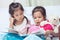 Lovely twin sister two child girls having fun to read a cartoon