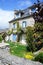 Lovely typical Breton stone house with blue shutters and a garden with roses