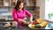 Lovely Vietnamese woman in a red dress prepares traditional Vietnamese tea