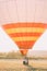 Lovely vintage dressed just married are sitting in the airballoon in the field.