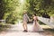 Lovely wedding couple wood forest. Bride and groom, follow me, married couple, woman in white wedding dress and veil. Rustic