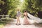 Lovely wedding couple wood forest. Bride and groom, follow me, married couple, woman in white wedding dress and veil. Rustic