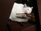 A lovely white cat laid down on a wooden chair and falled asleep