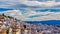 Lovely whitewashed Spanish town with tradidional roof construction set on a hill. Deep blue sky