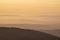 Lovely Winter landscape view from Red Screes across misty layers of mountains towards the East