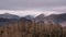 Lovely Winter sunrise landscape image of view from Walla Crag in Lake District towards distant mountains with low cloud