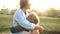 Lovely woman and her adult teenage daughter hug each other, standing in the middle of an autumn park. Outdoor portrait