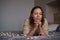 Lovely woman lying on bed with glowing lights