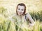 Lovely woman posing in the wheat cobs by sunset, natural beauty