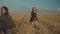 Lovely women rejoicing in wheat field at sunset