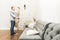 Lovely young couple in a living room with a modern interior face to face.