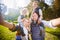 Lovely young couple taking selfie photo self portrait carrying son and daughter on shoulders posing happy smile. Point View Shot