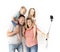Lovely young couple taking selfie photo self portrait with stick and mobile phone carrying son and daughter on shoulders posing ha