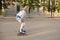Lovely young girl enjoying rollerblading outdoors