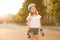 Lovely young girl enjoying rollerblading outdoors