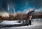 Lovely young lady posing dramatically with long black veil in winter scenery. Blonde woman with cloudy sky in background - outdoor