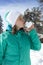 Lovely young woman kissing snow heart