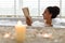 Lovely young woman lying in foamy bath, reading book in relaxing atmosphere with candles, indoors. Copy space