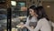 Lovely young woman talking to a customer at her bakery store