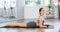 Lover of active lifestyle on yoga mat perform doing bhujangasana in gym
