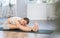 Lover of active lifestyle on yoga mat perform doing Pashchimottanasana in gym