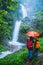 Lover asian man and asian women travel nature Travel the highest waterfall in Chiangmai Mae-pan waterfall rainy season at Doi