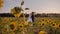 Lovers boy and girl stand opposite each other in a beautiful field of sunflowers.