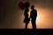 Lovers couple silhouettes with heart shape balloon. Generative AI