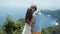 Lovers hug on background of beautiful view of ocean from mountain, slow motion