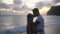 Lovers kissing at sunset on the beach, romantic evening in an exotic location