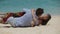 Lovers lying down on the beach