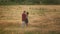 Lovers man and woman travel in the field holding hands. Follow me, a young happy couple running along golden wheat field