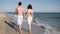 Lovers people walking around arm barefoot on sand, Summer, couple romantic walk on beach, couple in love, an exotic