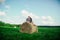 Lovers resting in a field near haystacks